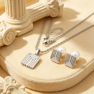 Detailed close-up of French vintage geometric stainless steel jewelry set with pearls.