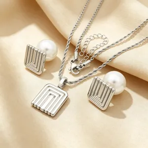 Detail view of vintage square stainless steel jewelry set featuring white pearl inlay