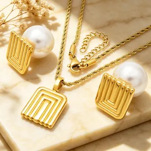 Detail of French retro gold stainless steel jewelry set with pearls and geometric pendants