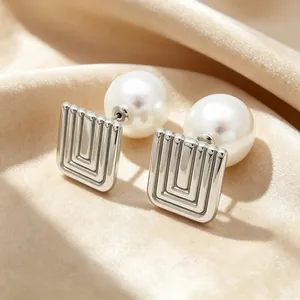 Detail view of retro square stainless steel earrings with elegant pearl backing