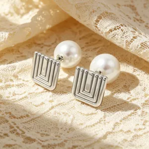 Close-up of French vintage square geometric stainless steel earrings with pearls