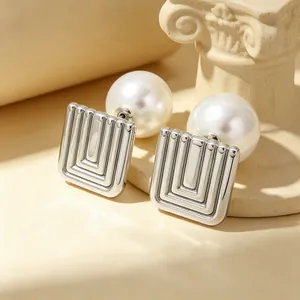 Close-up of French vintage square earrings with spiral grooves and back pearls