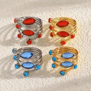 Group of French style wrap rings with red and blue gemstones in gold and silver finish