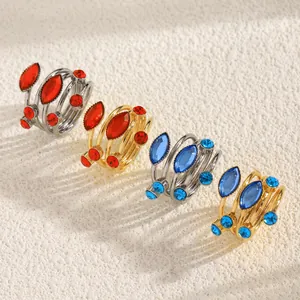 Detail of French geometric spiral rings with red and blue rhinestones in gold and silver