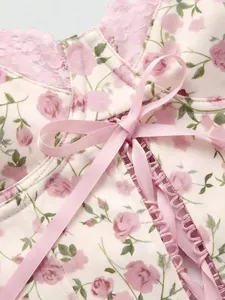 Close-up of pink rose floral print milk silk camisole with lace-up ribbon back