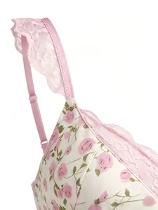 Close-up of pink rose print camisole with delicate lace trim shoulder straps