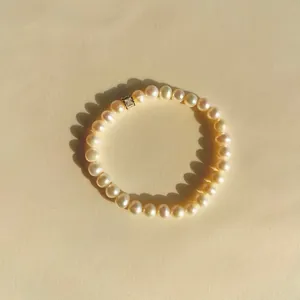 Detail shot of baroque freshwater pearl bracelet with a sparkling square zircon bead.