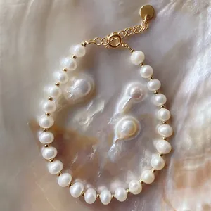 Close-up of a baroque freshwater pearl bracelet with gold bead accents on shell