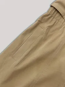 Close-up of the fine stitching and elastic waist detail on this khaki shirt dress