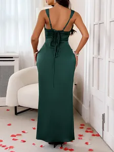 Detail view of elegant dark green satin backless maxi dress with tie-up back details