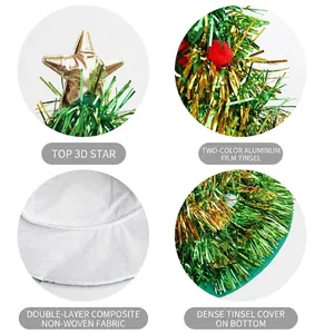 Details of a festive Christmas tree hat with green tinsel and a shiny gold star topper