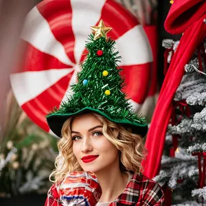 A young woman wearing a creative festive green tinsel Christmas tree hat with ornaments