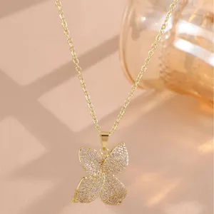 Elegant gold-plated four-leaf clover necklace with sparkling pavé-set stones for women.