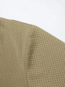 Close-up macro view of the premium honeycomb waffle knit texture on a men's polo shirt