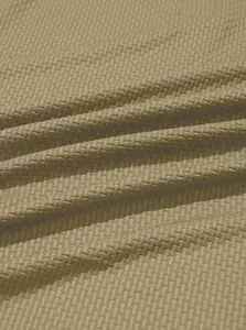 Close-up of khaki waffle-knit fabric showing honeycomb texture and stretch detail