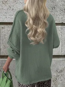 Back view of a casual oversized green knit sweater showing textured stitch detail