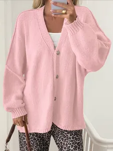 Detailed view of soft pink oversized knit cardigan featuring button-down V-neck style