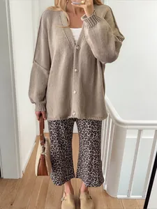 Oversized beige knit cardigan with buttons and leopard print pants for women