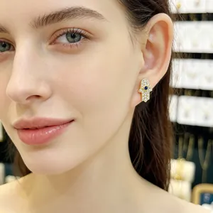 Elegant gold-plated Hamsa Hand stud earrings featuring blue evil eye and white zircons