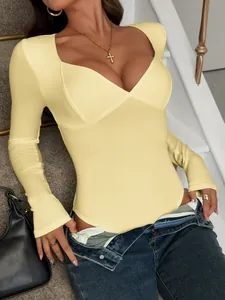 Detailed view of a pale yellow Y2K spicy girl style long-sleeve bodysuit with V-neck.