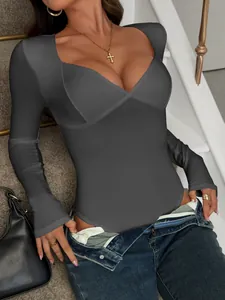 Close-up detail of a dark grey long sleeve sweetheart neck bodysuit worn with denim jeans
