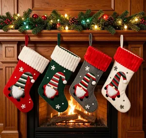 Large cloth Christmas stockings with cartoon gnome patterns hanging over a fireplace