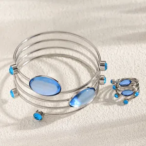 Close-up of a French geometric jewelry set with sparkling blue oval gemstones