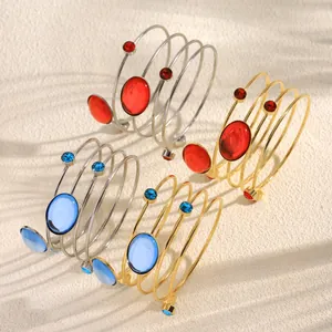 Adjustable multi-layer geometric cuff bracelets featuring red and blue oval gemstones