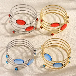 Set of four French style coiled geometric bracelets with colorful gemstones