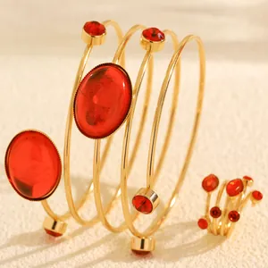 Close-up of French style red gemstone and rhinestone spiral bracelet and ring set