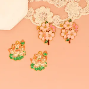 Detailed view of delicate enamel cherry blossom and lotus charms for DIY jewelry making crafts