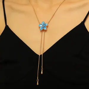 Detailed close-up showing a blue flower enamel pendant on an adjustable gold snake chain necklace