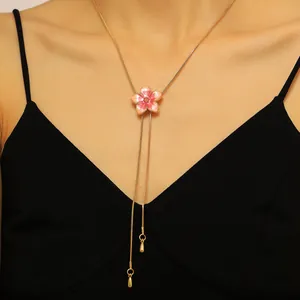 Detail view of sweet pink flower enamel necklace with adjustable gold slide chain