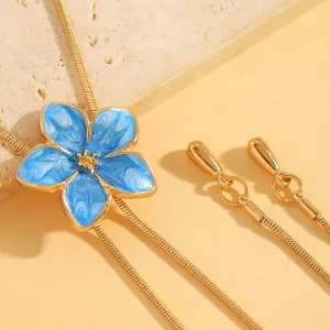 Close-up of a blue oil-dripping flower necklace showing golden snake chain details