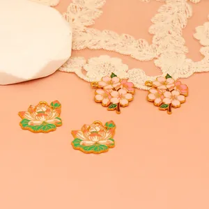 Detail view of colorful cherry blossom and lotus flower enamel pendants for DIY jewelry.