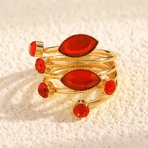 Detailed macro view of French style wrap ring with red rhinestones and gold finish