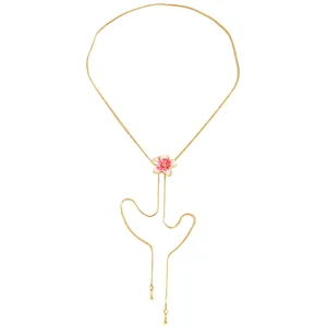 Detailed close-up of a gold-toned necklace featuring a pink enamel flower pendant