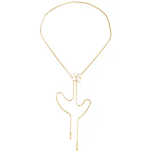 Detailed macro shot of an adjustable gold necklace with a white enamel flower pendant