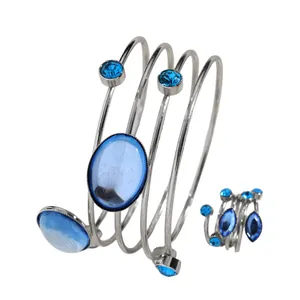 Close-up detail showing the silver-plated geometric wrap jewelry set with blue gemstones
