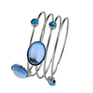 Detail view of a French geometric wrap bangle with blue gemstones and rhinestones