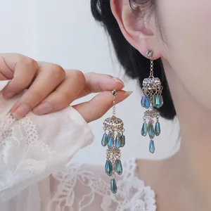 Détail de boucles d'oreilles vintage élégantes avec des cristaux bleus en forme de goutte