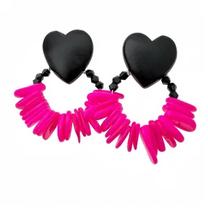 Statement heart wooden earrings featuring bright pink shell fringe and faceted black beads