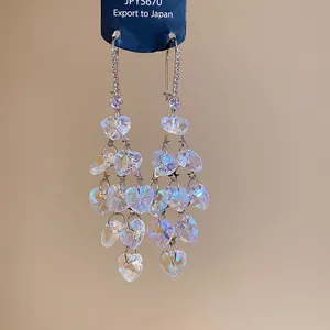 Macro detail of heart-shaped glass tassel earrings with sparkling zircon crystals