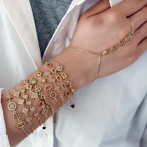 Close-up of gold-plated adjustable bracelets with cubic zirconia and hand chain detail