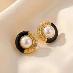 Détails macro des boucles d'oreilles vintage en émail et perle avec finition dorée
