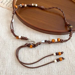 Exquisite detail view of bohemian vintage beaded waist chain with artisanal wooden accents