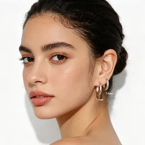 Detail view of 14mm and 16mm S925 silver minimalist hoop earrings on model ear