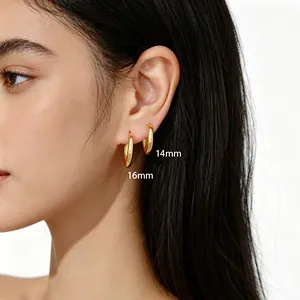 Detail view showing 14mm and 16mm minimalist gold polished hoop earrings on model's ear