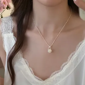 Close-up detail of an elegant silver necklace featuring a minimalist popcorn pearl pendant