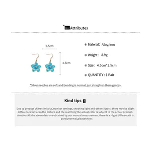 Detailed view of blue enamel flower earrings showing 4.5cm length and alloy material